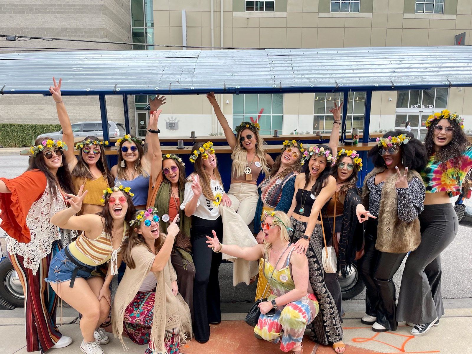 A bachelorette crew in flower crowns celebrating on the party bike