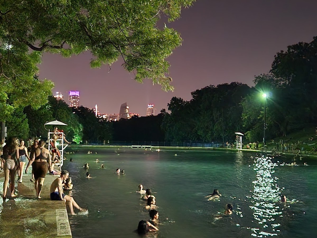 Swimmers in the spring-fed green water of Barton Springs Pool in Austin