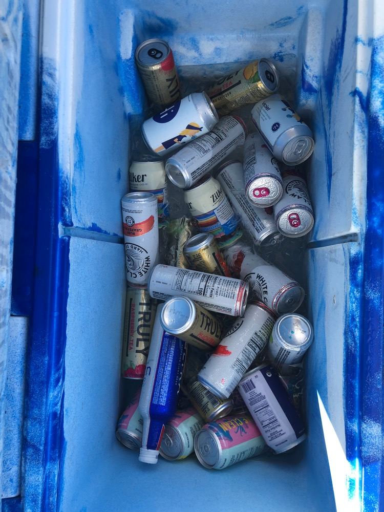 The beer bike cooler packed with BYOB cans and seltzers on ice