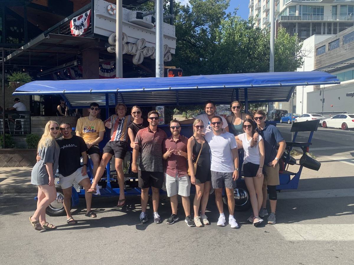 A mixed group with the Austin Bar Bike outside a West 6th bar after their ride
