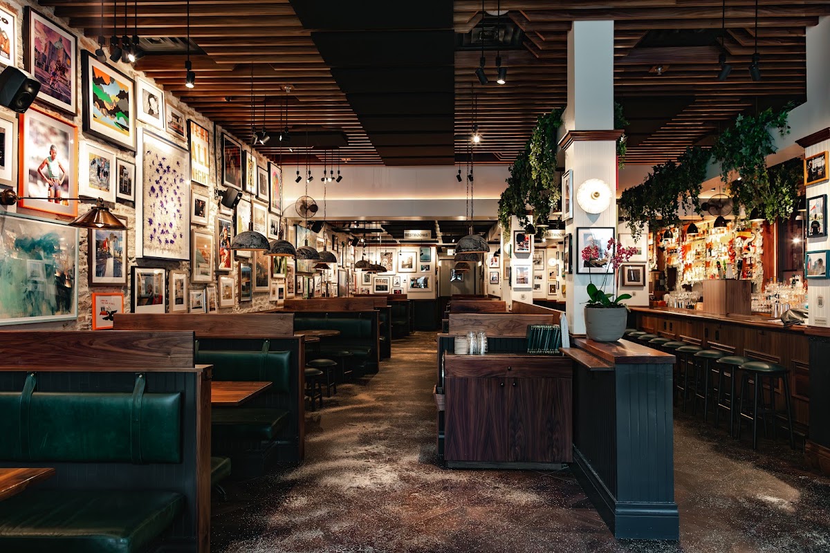 Wooden tables and framed artwork inside The Dead Rabbit Irish pub on East 6th Street in Austin