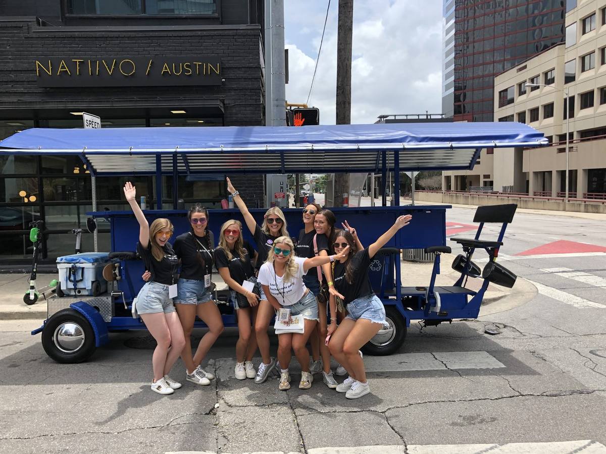 Group photo in front of the blue party bike