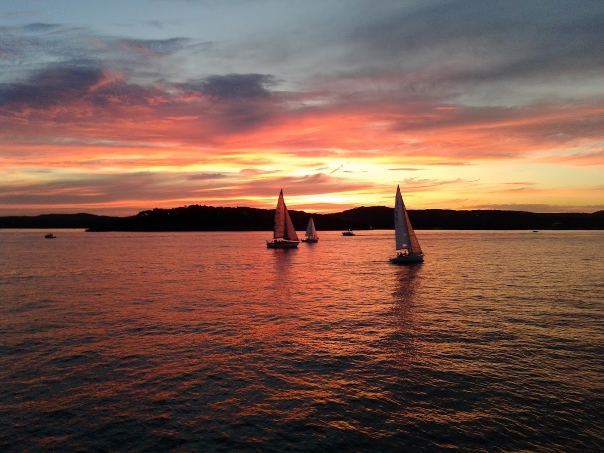 Boats on Lake Travis at sunset near the Mansfield Dam marinas outside Austin