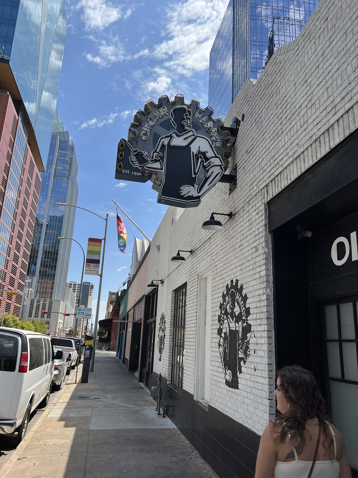 The neon-lit brick facade of Oilcan Harry's on West 4th Street in Austin at night