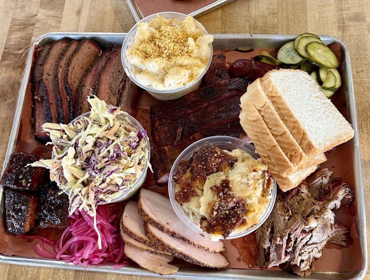 Brisket, sausage and seasonal smoked vegetable sides at InterStellar BBQ near Austin
