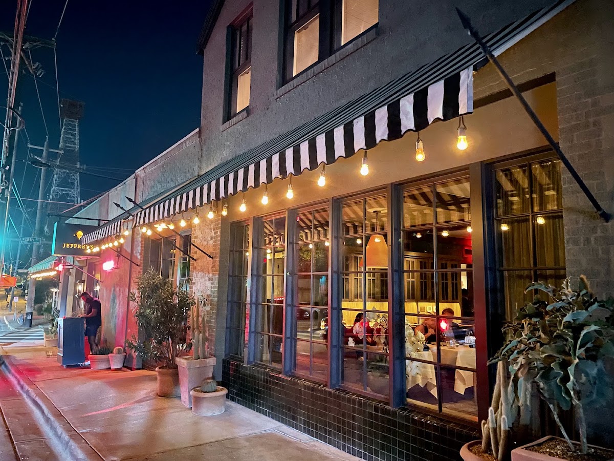 The striped awnings and corner dining room of Jeffrey's in Austin's Clarksville neighborhood at night