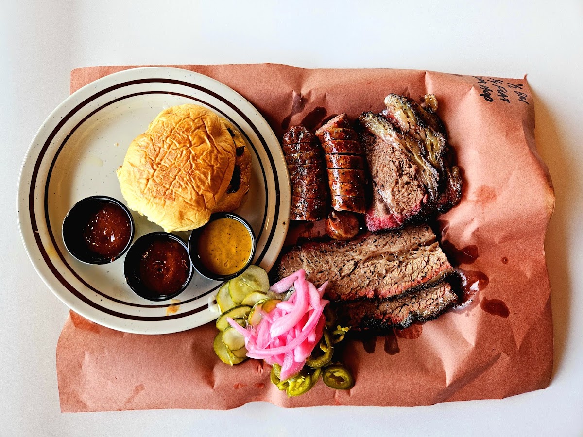 Beef cheeks, brisket and creative sides on a tray at LeRoy and Lewis Barbecue in Austin