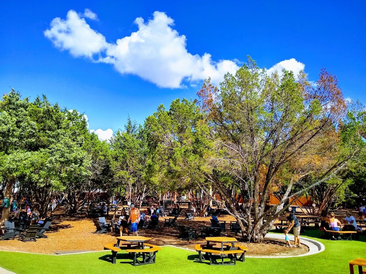 Picnic tables and food trucks in the outdoor yard at Meanwhile Brewing Co in southeast Austin