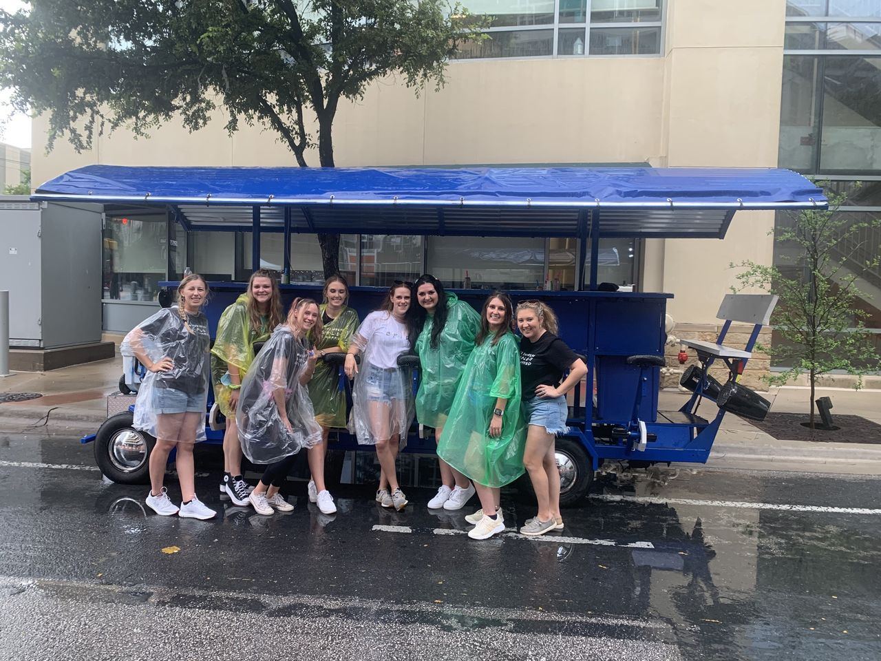 The Austin Bar Bike rolling downtown on a rainy evening near the Warehouse District